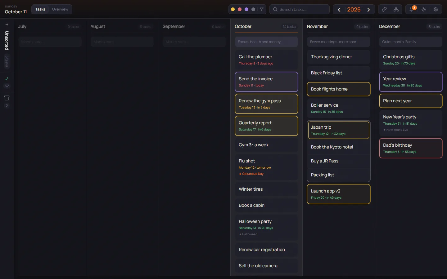 The Tasks page in PLANYEAR: monthly columns of task cards side by side, some highlighted in yellow, red or purple